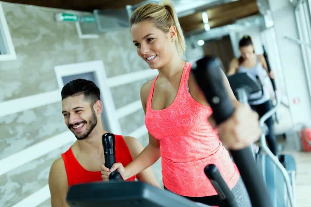 Attractive woman working cardio exercises with trainer